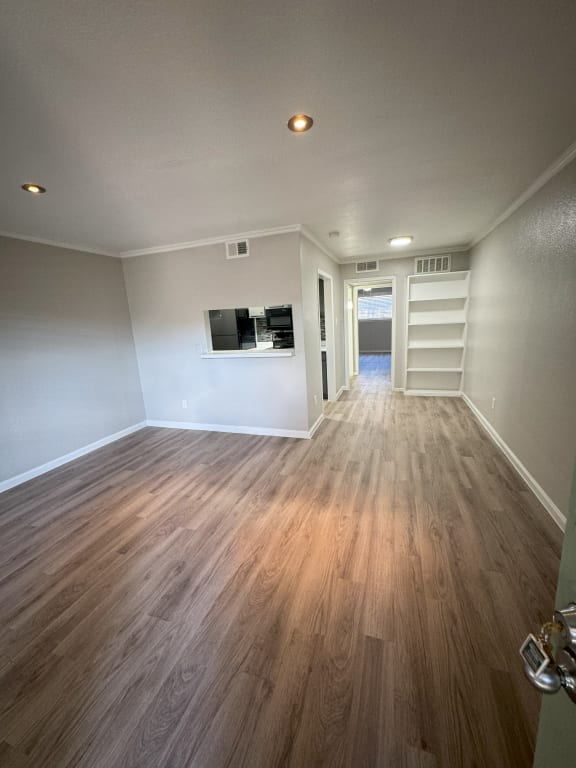 a living room with wood floors and white walls