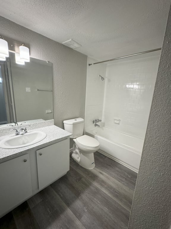 an empty bathroom with a sink toilet and shower