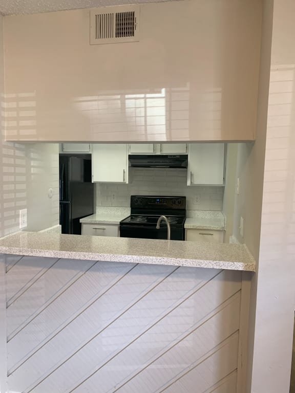 a kitchen with white cabinets and a counter top  at 1505 Exchange Apartments, Texas, 76112
