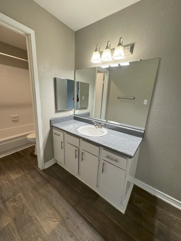 an empty bathroom with a sink and a mirror