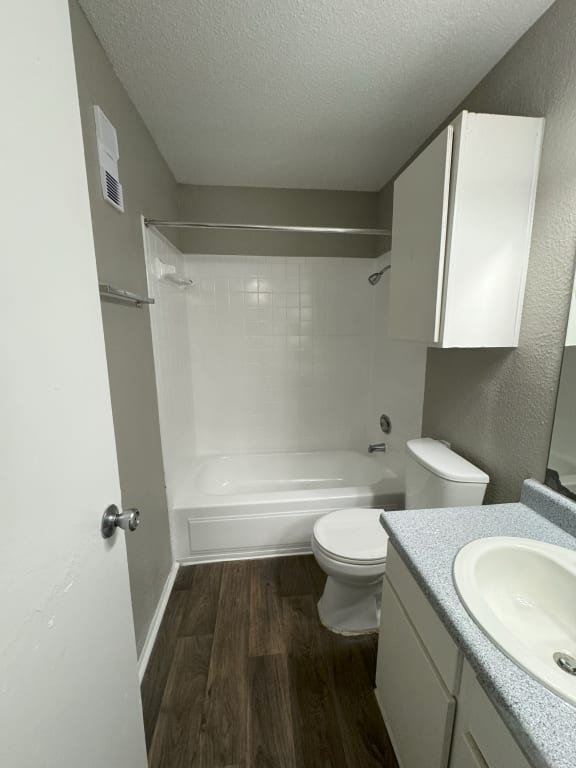 an empty bathroom with a sink toilet and shower