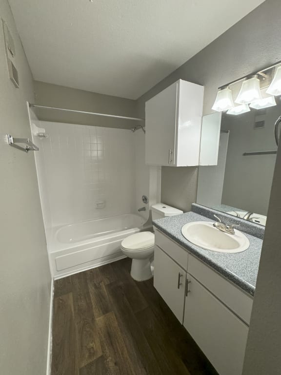 an empty bathroom with a sink toilet and shower