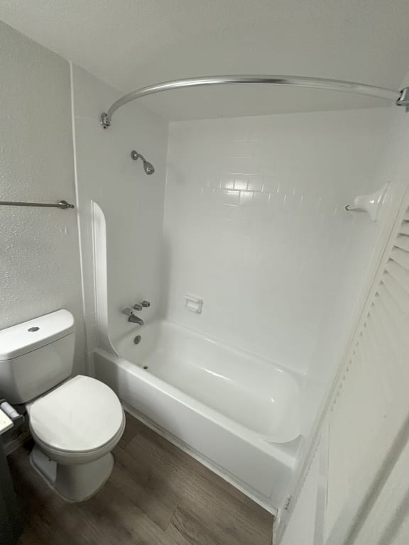a small bathroom with a toilet and a tub