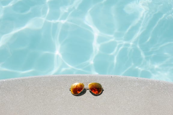 a pair of sunglasses on the edge of a pool  at Tara Oaks, Houston, TX, 77092