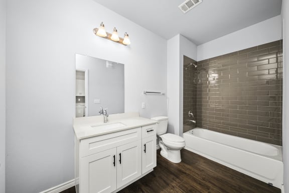a bathroom with a white sink and a shower and a toilet
