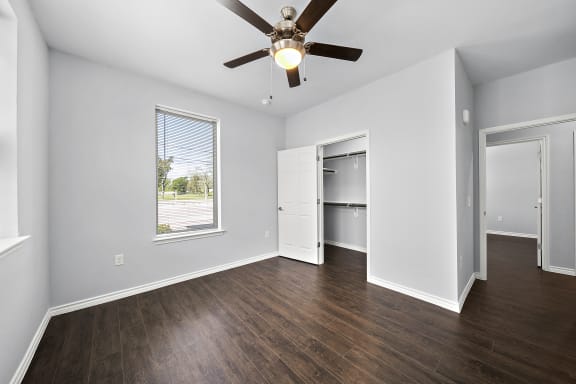 Empty bedroom with closet and hardwood floors at The Aurea Apartments, Houston, TX 77093