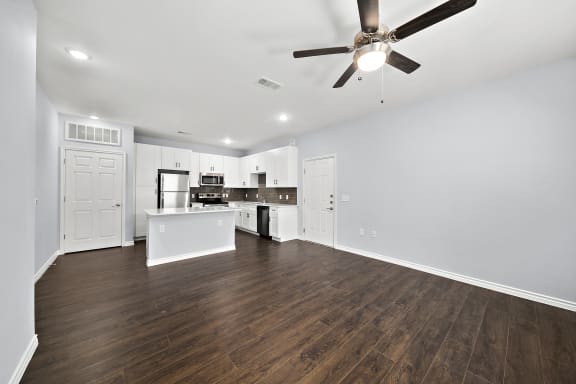 Open concept living space with white kitchen at The Aurea Apartments, Texas, 77093