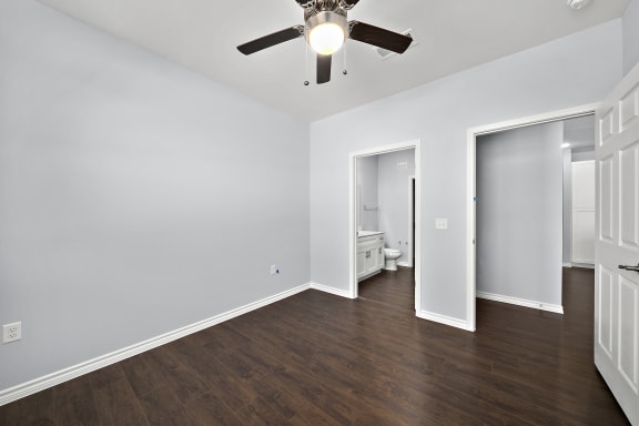 Empty bedroom with closet and bathroom access at The Aurea Apartments, Houston