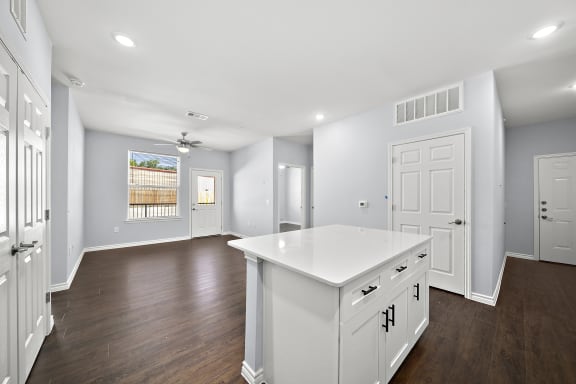 Open concept kitchen with white island at The Aurea Apartments, Houston, Texas