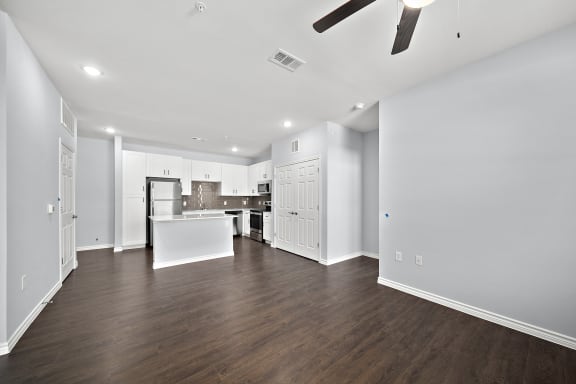 Open concept apartment with white kitchen at The Aurea Apartments, Texas