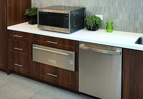 A modern kitchen with a microwave, oven, and dishwasher.