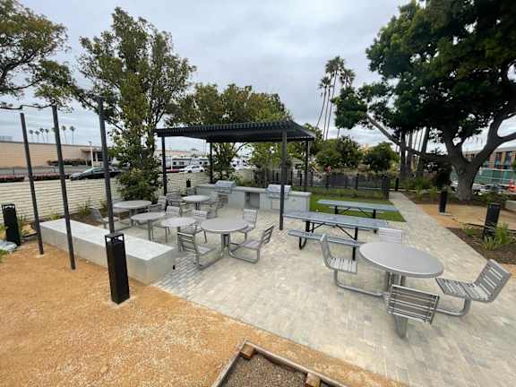 A park with a gazebo, picnic tables, and chairs.
