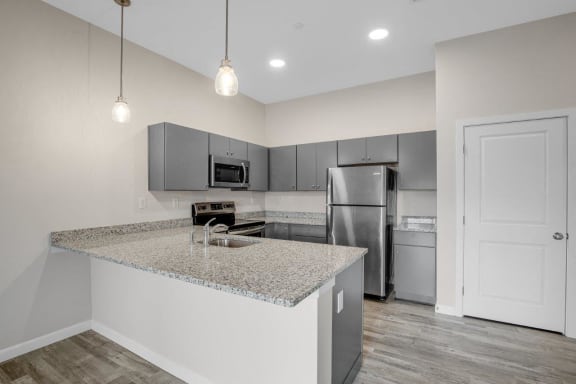 a kitchen with stainless steel appliances and a granite counter top