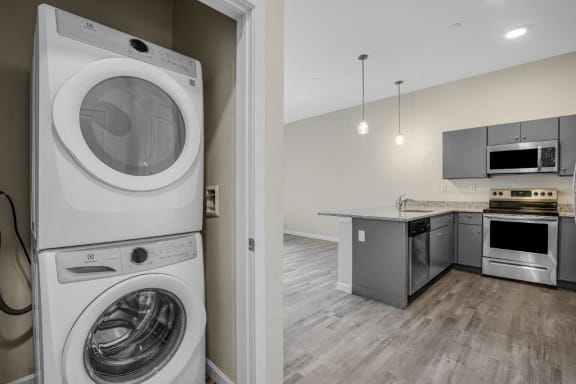 a washer and dryer in a laundry room with a kitchen