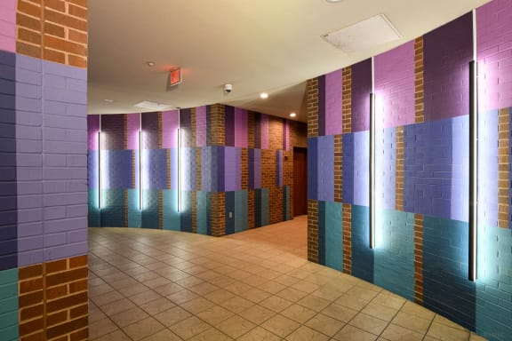 a view of a hallway with colorful tiles on the walls