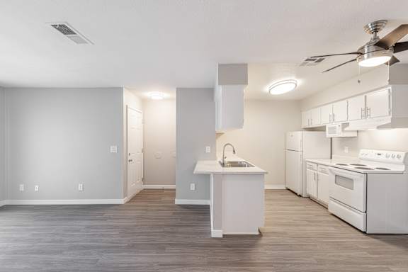 a kitchen with white appliances and a white counter top