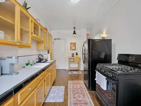 Kitchen with black refrigerator at The Langham Apartments, California, 90005