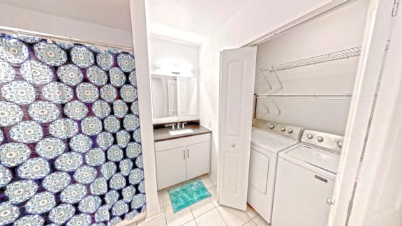 a kitchen with a white stove and a sink and a shower