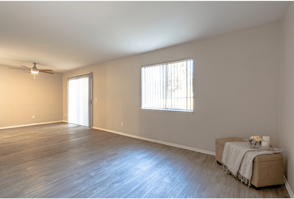 a bedroom with hardwood floors and a ceiling fan