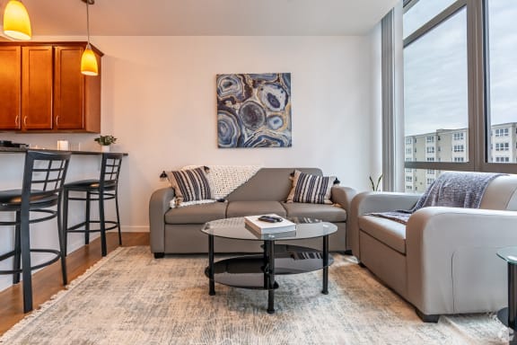 a living room with a couch and a table and a window