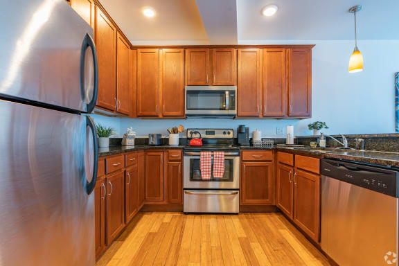 a kitchen with stainless steel appliances and wooden cabinets