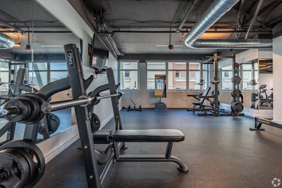 a fitness room with weights and other exercise equipment