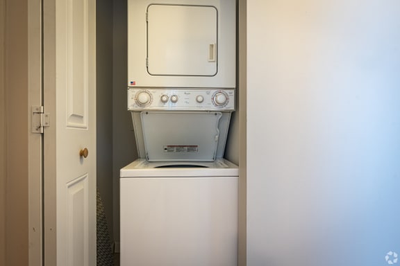 an empty laundry room with a washer and dryer