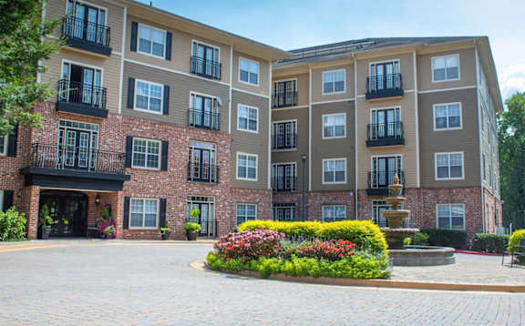 A large brick building with a courtyard in front.at The Orleans of Decatur, Decatur, GA, 30033