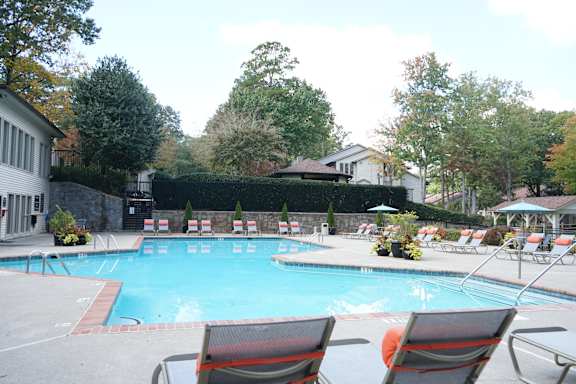 A pool with chairs around it. at Seven Pines, Georgia, 30022