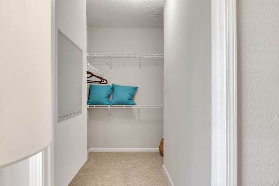 A white closet with a coat hanging on the rack. at Echo at Lake Norman, Mooresville, NC