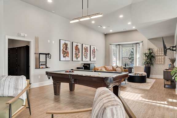 A living room with a pool table and a couch. at Echo at Lake Norman, Mooresville, NC