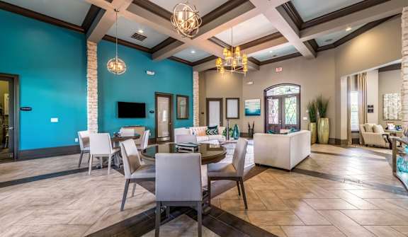 lounge room with blue walls and a table with chairs at Echo at Lake Norman, Mooresville, NC