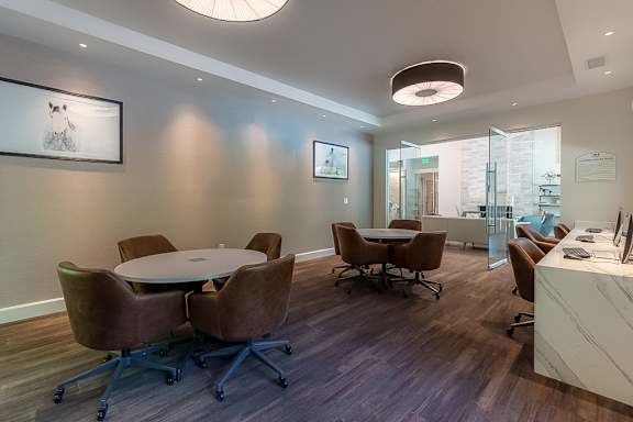 A conference room with a table and chairs.