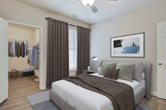 A bedroom with a bed, a ceiling fan, and a painting on the wall.