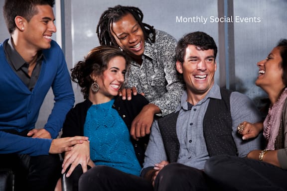 A group of people are sitting together and laughing.