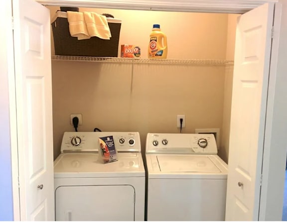 A small laundry room with a washer and dryer.
