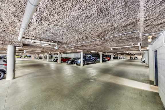 A parking garage with cars parked in it.