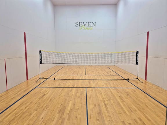 A squash court with the word SEVEN on the wall.