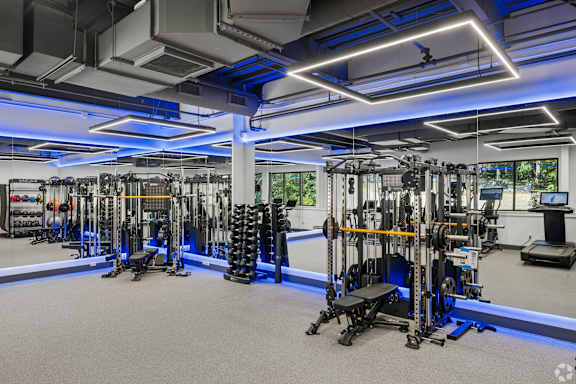 A gym with a variety of equipment including weights and machines.