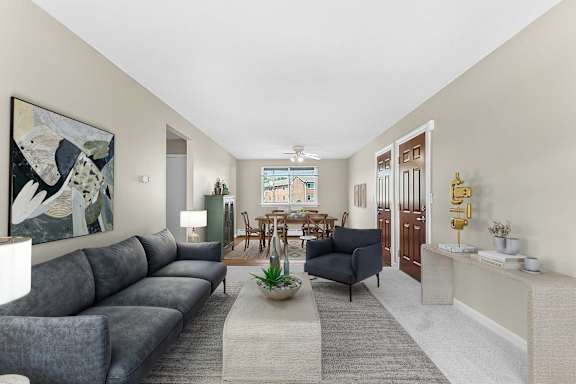 A living room with a grey sofa and a painting on the wall at Rose Hill Estates, Norwich, CT, 06360