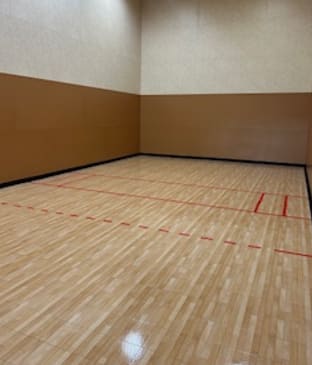A racquetball court with red lines on the floor at Dominion Courtyard Villas, Fresno