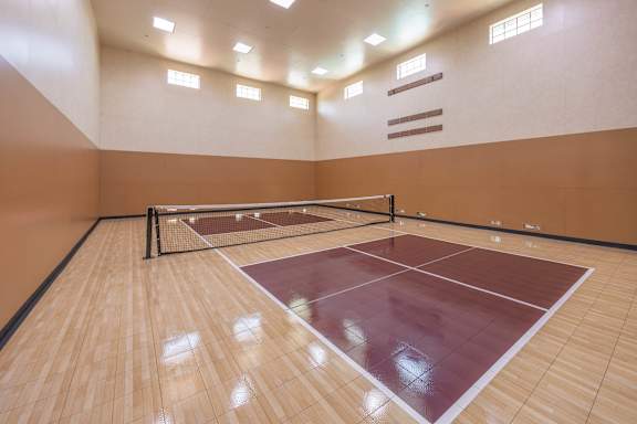 A squash court with a net and two players.