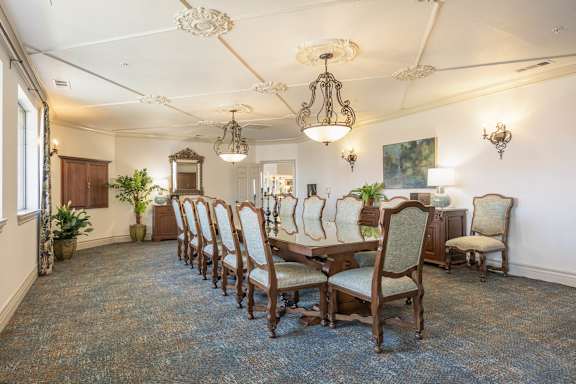 A room with a long table and chairs.