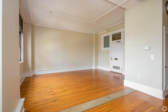 A room with wooden floors and a white door.