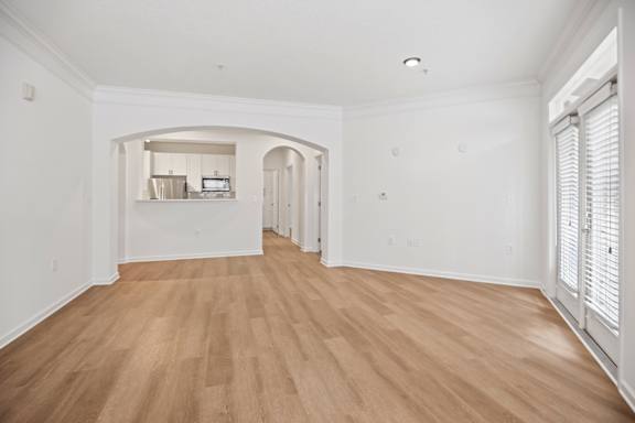 A room with wooden floors and white walls.