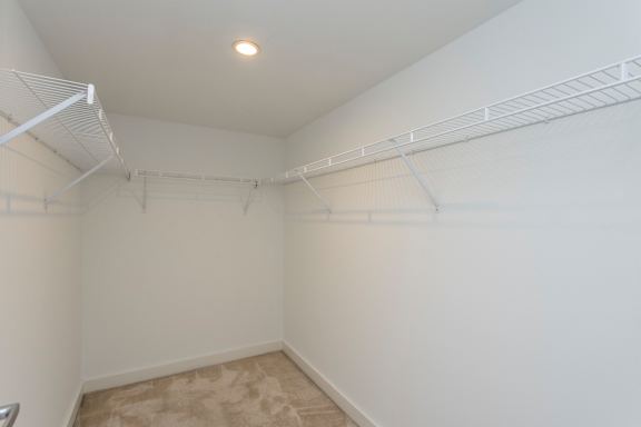 A room with white walls and a beige carpet.