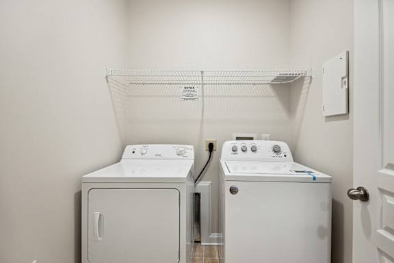 A white dryer and washer in a laundry room.
