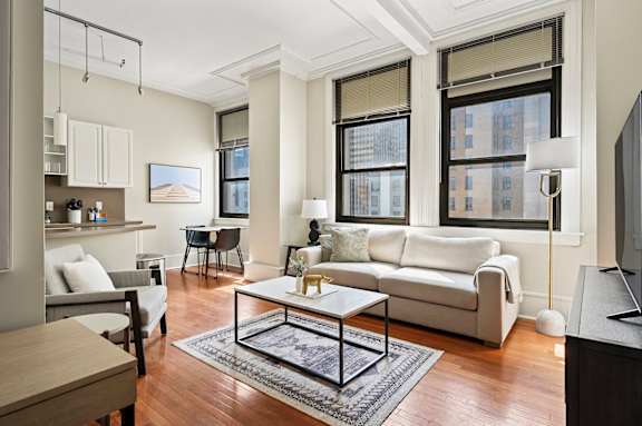 A living room with a white couch and a coffee table.
