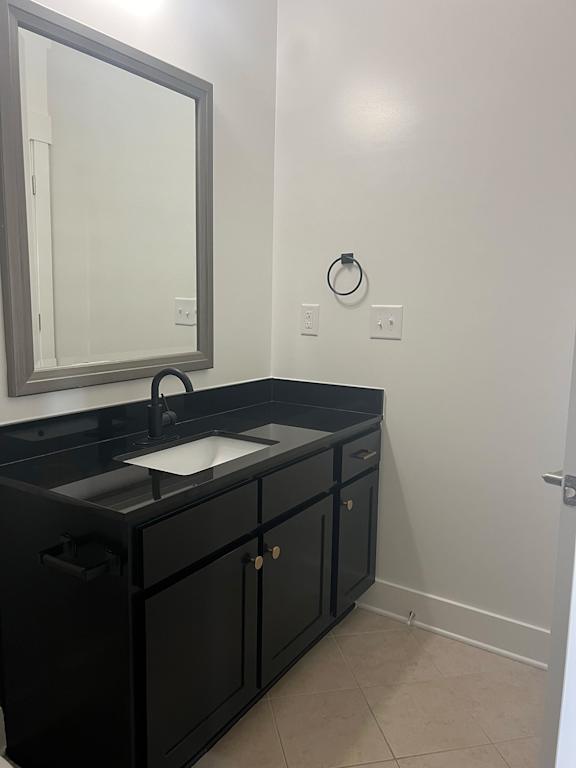 A bathroom with a sink and a mirror.