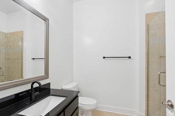 A bathroom with a white toilet and a sink.